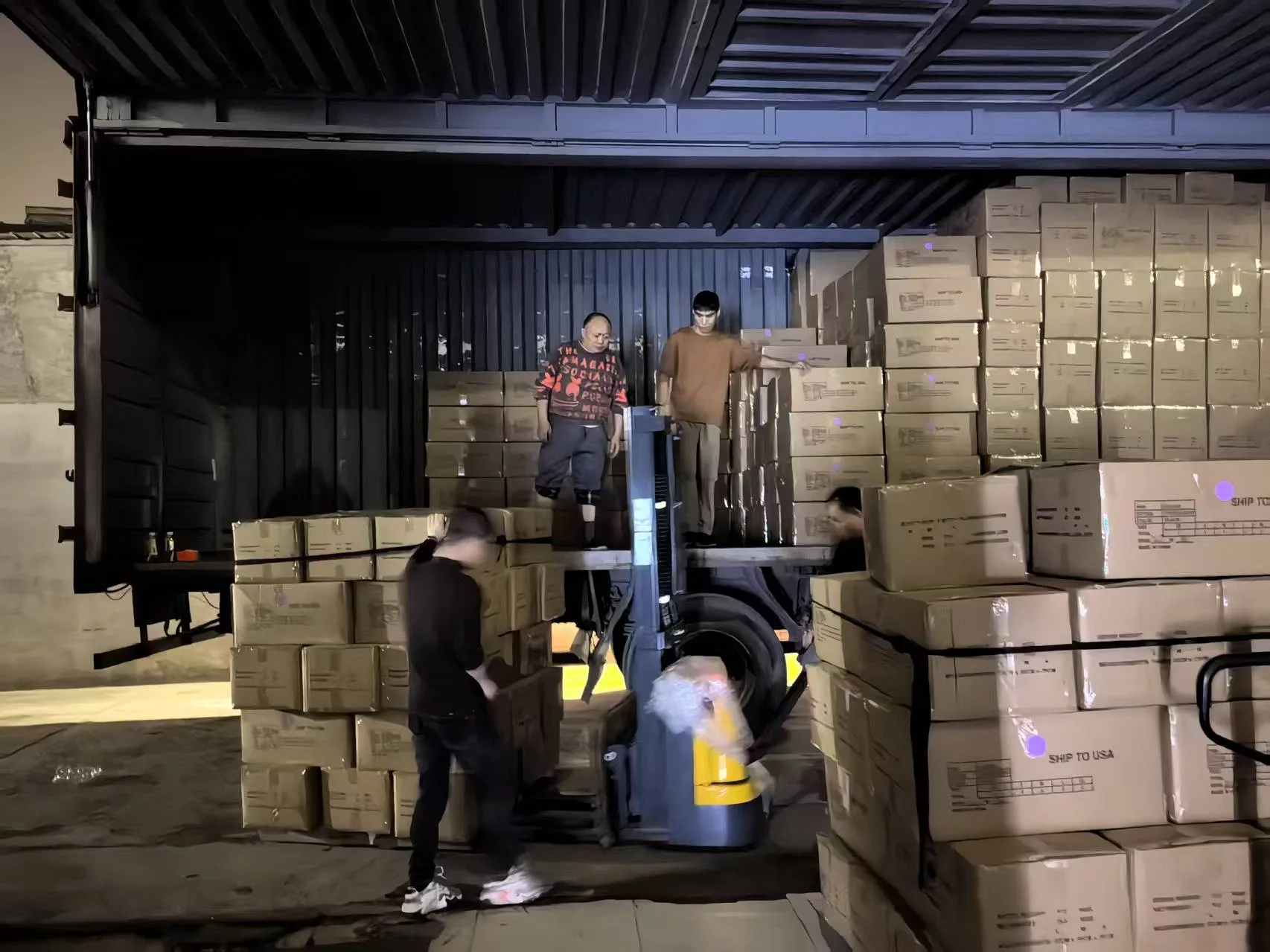 Factory team loading packed garment cartons for shipment