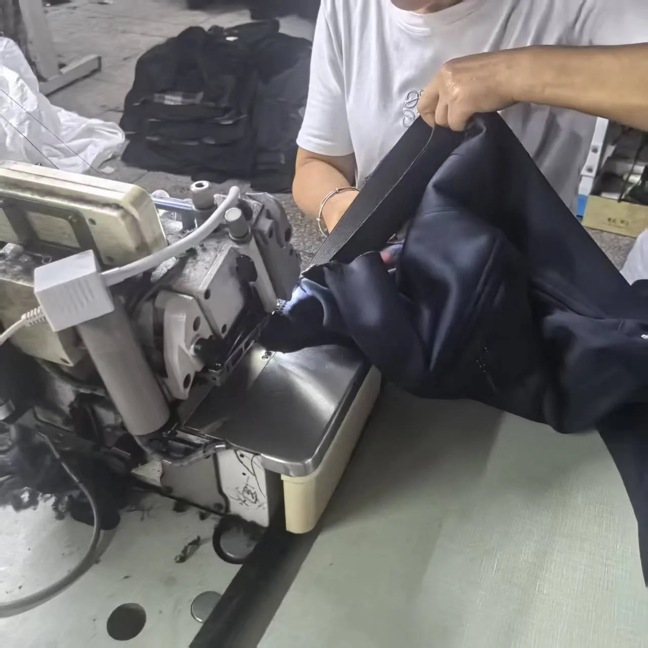 Operator sewing the waistband of a pair of pants