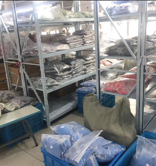 Organized swimwear pieces and packed garments in the production area