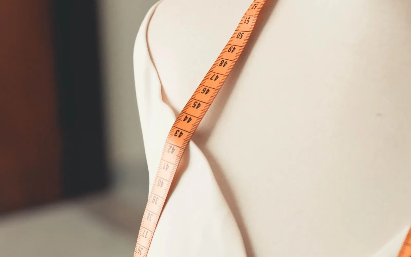 Measuring tape positioned on a dress form for garment measurement review