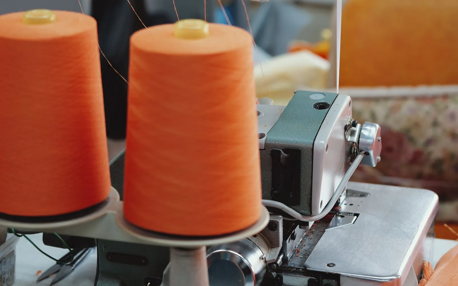 Industrial sewing machine and thread spools used to illustrate production setup