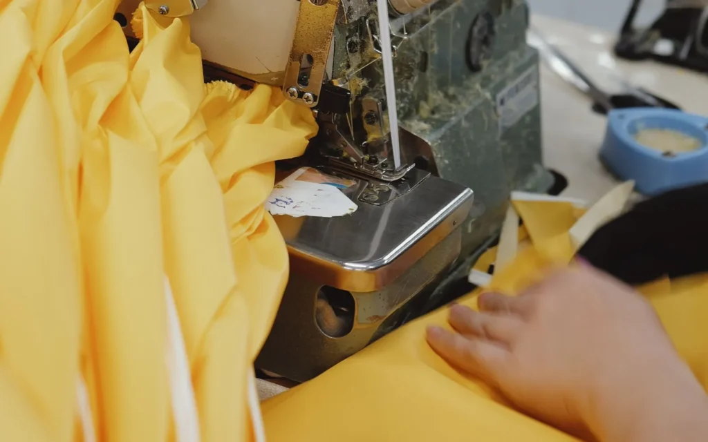 Close-up of fabric being sewn during sample construction